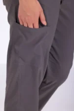 Close-up of a person's hand resting inside a gray pocket on loose-fitting pants. The fabric appears soft and comfortable, conveying a relaxed tone.