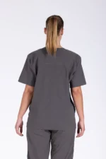 Close-up of a person wearing grey medical scrubs with their right hand casually in a side pocket. The fabric appears soft and comfortable.